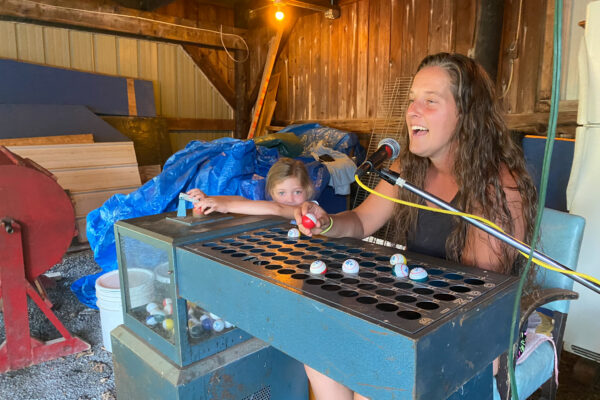 A woman calls bingo at the Hickory Corners Carnival