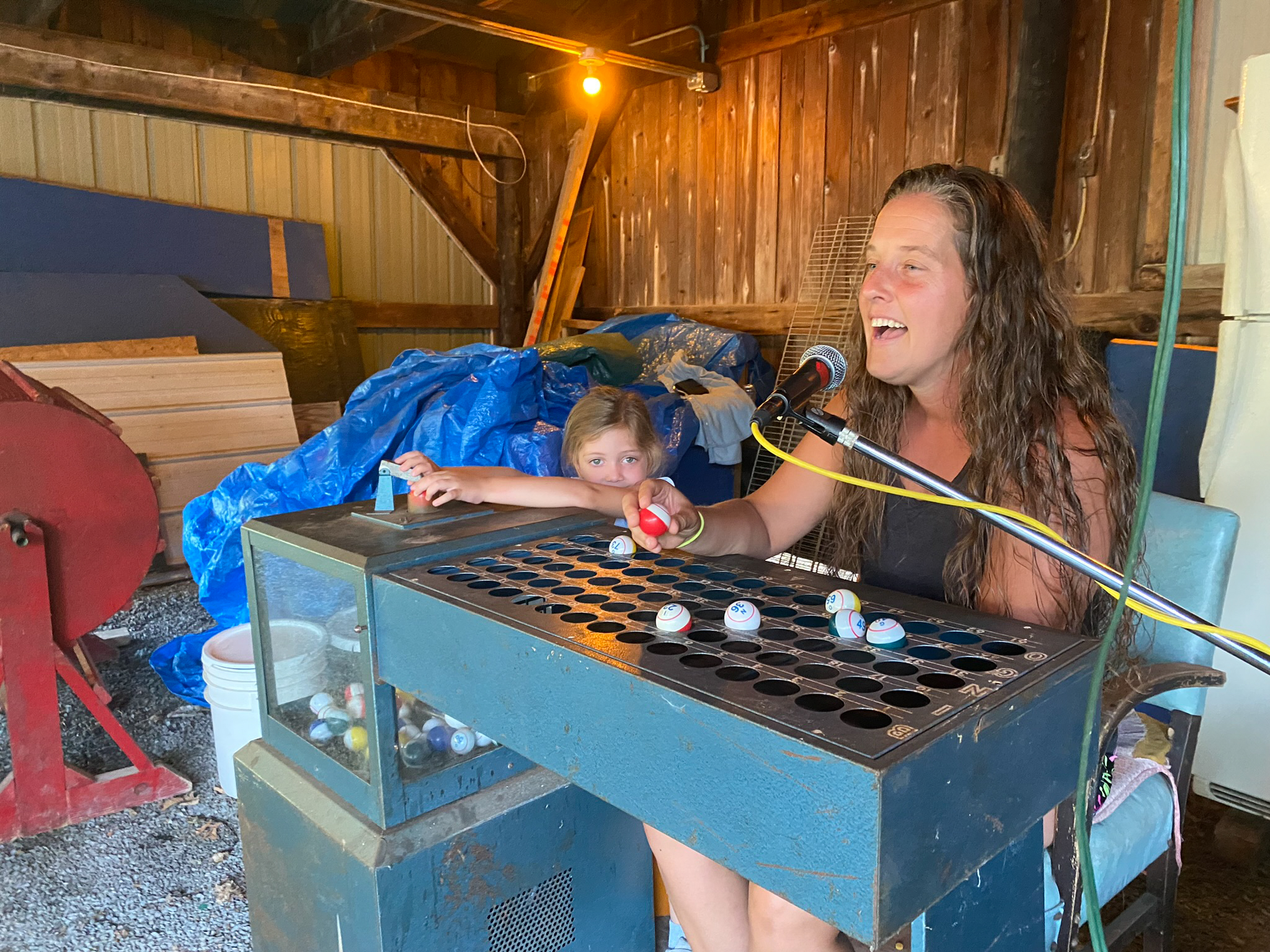 A woman calls bingo at the Hickory Corners Carnival