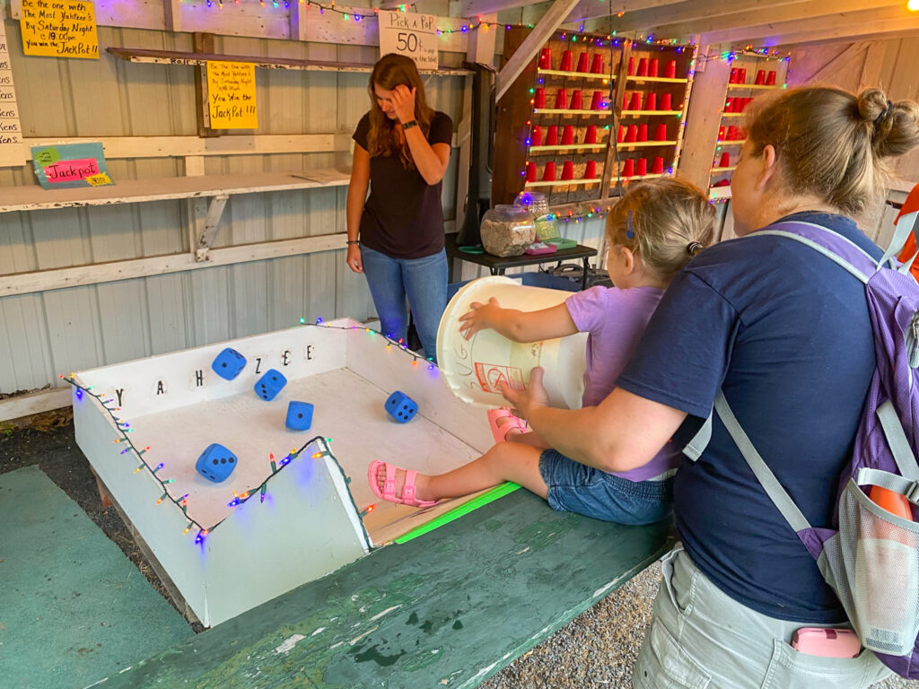 A child plays a game at the Hickory Corners Carnival